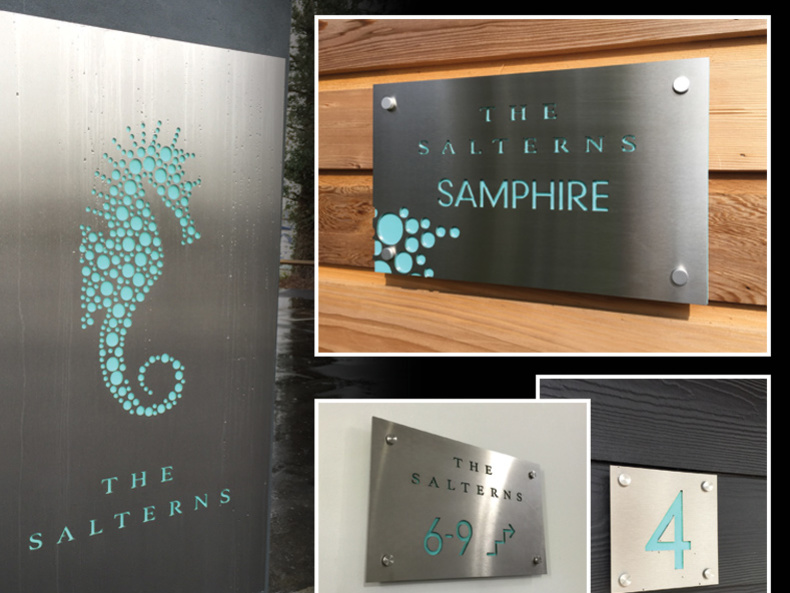 Stainless steel panels laser cut and backed acrylic with translucent vinyl applied  