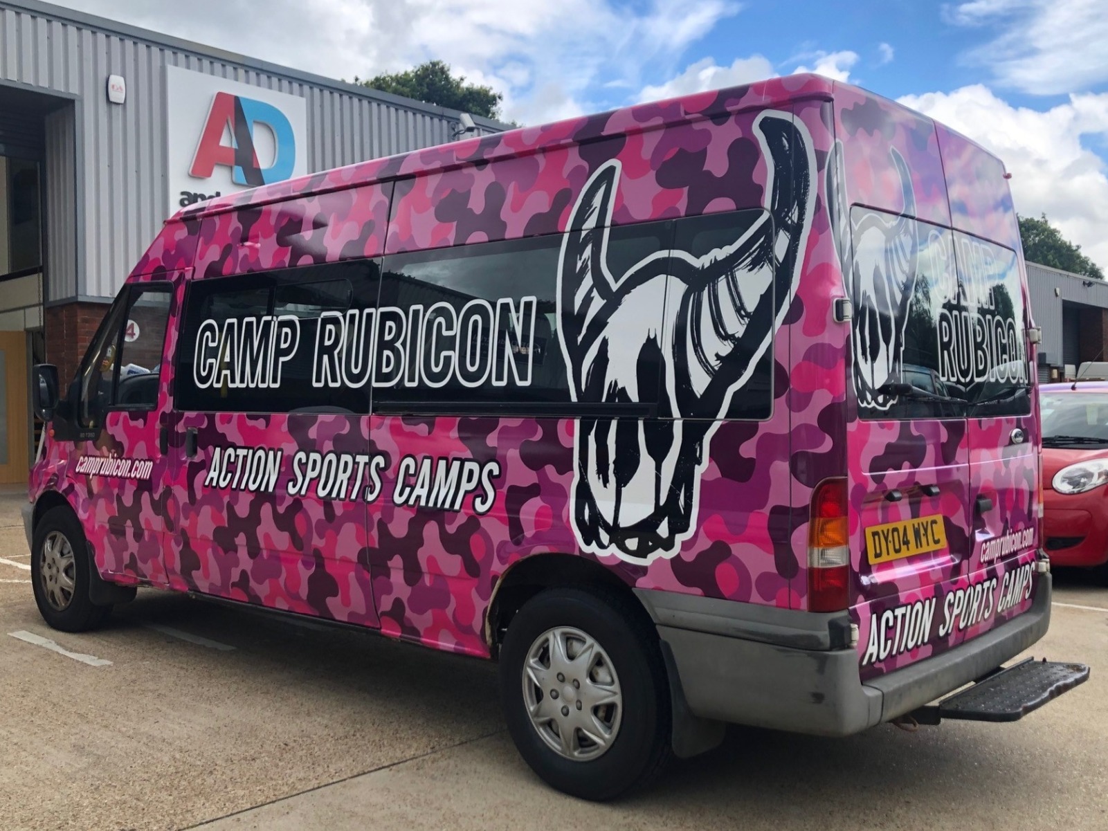 Pink camo full mini bus wrap with overlayed graphics